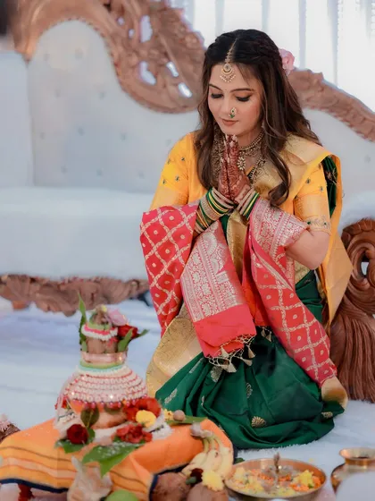 The bride participates in a pooja, looking serene and beautiful.