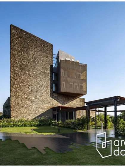This exterior shot of the Radisson Resort, featured in ArchDaily, showcases the building's bold form, with a massive stone facade and a cantilevered wooden volume emerging from the landscape.