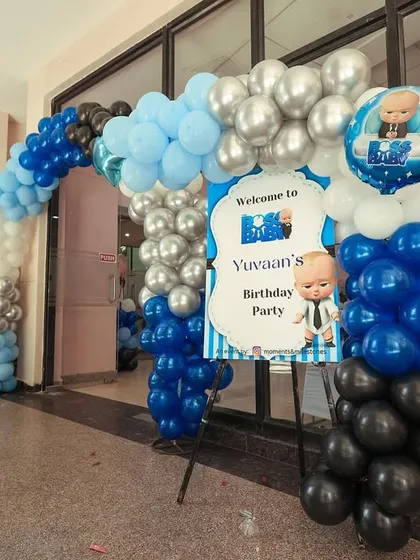 The entrance to Yuvaan's corporate takeover, with a blue, black, and silver balloon arch and a themed welcome sign.