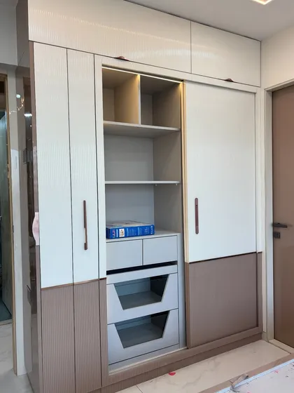 Another view of the combination wardrobe, showing how the internal lighting helps in finding items easily.