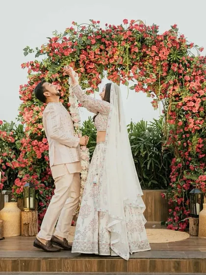 We harness the beauty of nature to create vibrant, romantic settings. This wedding ceremony featured a lush, sprawling arch of bougainvillea, providing a spectacular burst of color for the couple's special moment.