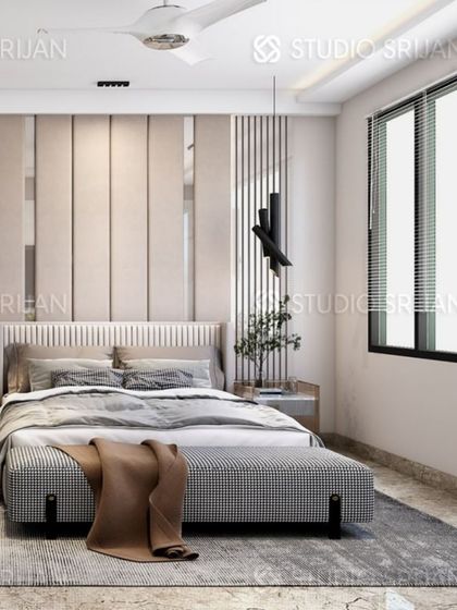 The bed in this Rajouri Garden room is set against a wall of light-colored vertical panels, creating a clean and modern look.