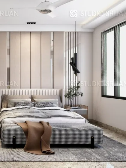The bed in this Rajouri Garden room is set against a wall of light-colored vertical panels, creating a clean and modern look.