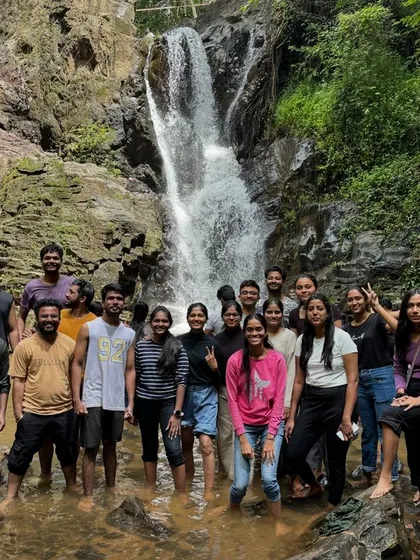 A large group photo in the refreshing waters of a waterfall on the Bandaje trek.