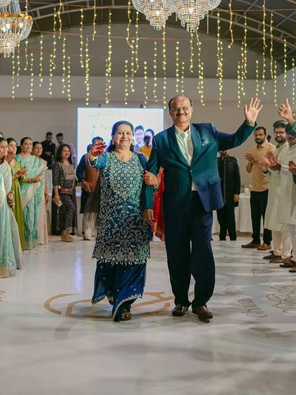 The parents of the couple make their own grand entrance, celebrated by family and friends lining the dance floor.