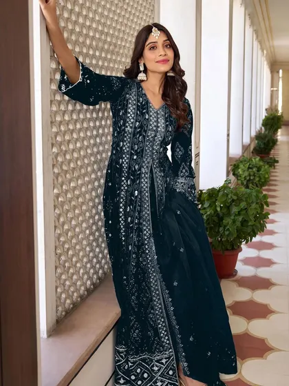This navy blue Anarkali is all about grandeur. The heavy thread, zari, and sequence embroidery on the velvet fabric make it a truly royal outfit for a winter wedding.