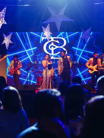 On stage for a Christmas Eve performance. The stage was decked out with stars and a custom LED backdrop featuring our logo, creating a festive and professional look.
