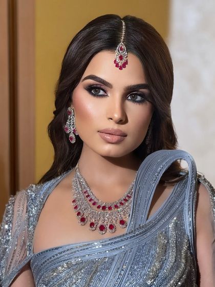 A close up of Kanu's cocktail look. The focus is on the beautifully blended smoky eye and the radiant highlight.