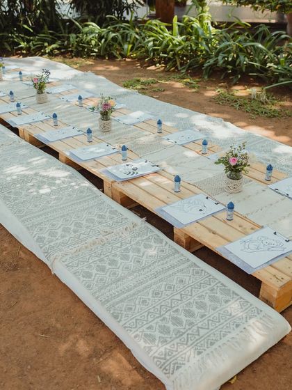 A dedicated kids' corner at a Mehendi, designed with low wooden tables and floor cushions. We provided coloring sheets and art supplies to keep the little ones happily entertained.