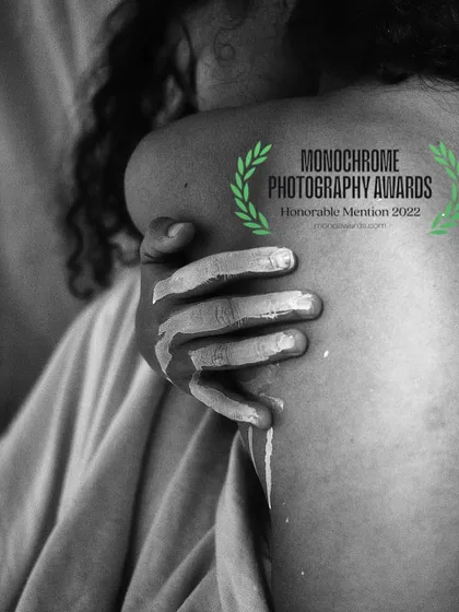 This image, which received an honorable mention at the Monochrome Photography Awards, is a study in texture and form. It’s about the connection between self and touch, using the simplicity of black and white to focus on the emotion and detail of the moment.