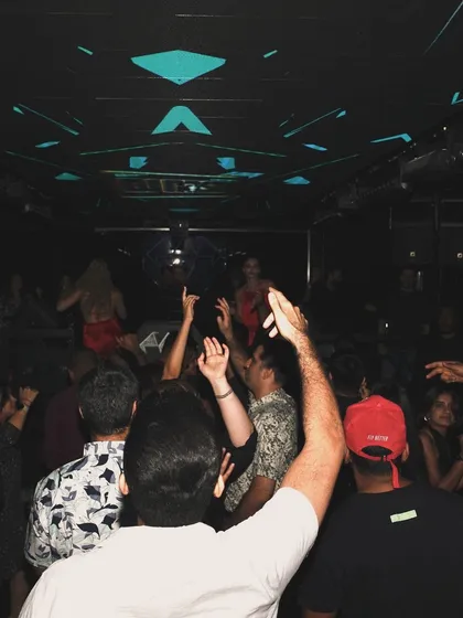 The crowd at ICY Dubai with their hands up, fully immersed in the set.