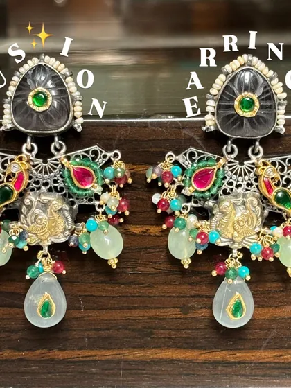 Intricate and colourful fusion earrings. This pair features detailed silver work, gold-plated accents, and a mix of semi-precious stones, creating a chandelier-like effect with beautiful movement.