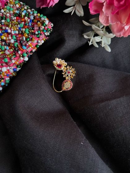 A styled shot of the American Diamond nath against a black cloth, highlighting its sparkle.