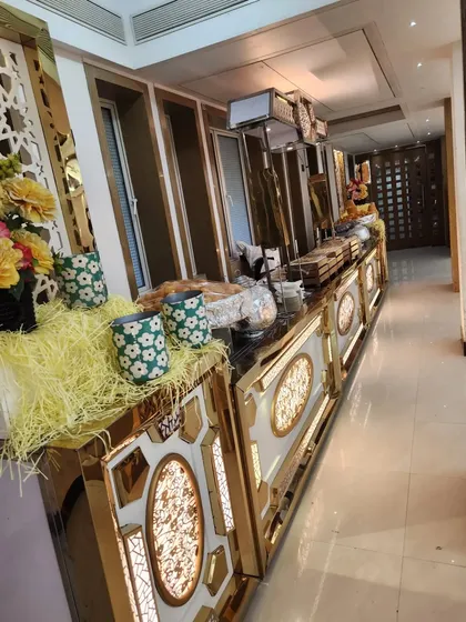 This is one of my premium buffet counter designs, featuring built-in lighting and elegant gold trim. I believe the food setup should be as impressive as the food itself, creating a luxurious atmosphere for your guests.