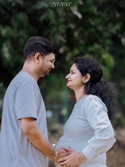 A sweet look between partners. This simple, classic pose highlights the couple's bond and excitement in a natural, outdoor setting.