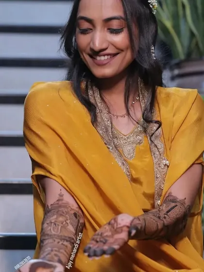 A smiling client admiring her intricate bridal mehndi. I love seeing my clients so happy with their designs.