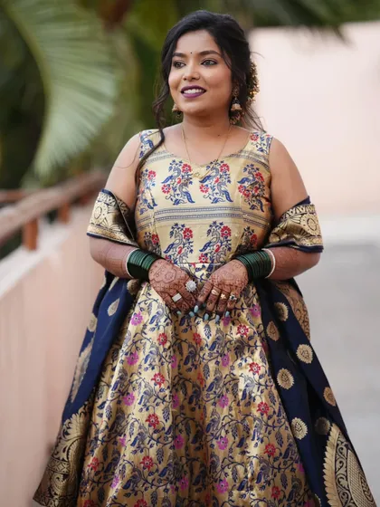 A beautiful portrait of the groom's sister, looking elegant in her traditional attire with her hands adorned with special mehendi for the occasion.