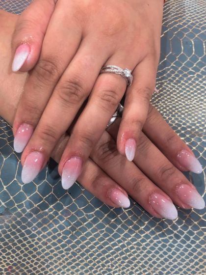 A classic pink and white ombre on a sharp, almond-shaped nail. This is a go-to look for elegance.