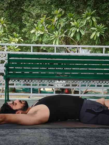 This is Supta Padmasana, the Lying Down Lotus Pose. It expands the chest to increase lung capacity and improves flexibility in the pelvic joints, making it a great restorative asana.