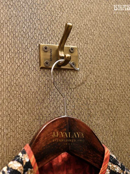 Even the smallest details were considered in the JJ Valaya collaboration. This custom brass coat hook, with its sturdy and elegant design, ensures that every element in the store, no matter how functional, adheres to the same standard of luxury.