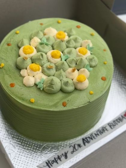 A minimalistic and chic green cake inspired by another baker's beautiful design. The simple piped flowers and clean lines make it a truly elegant piece.