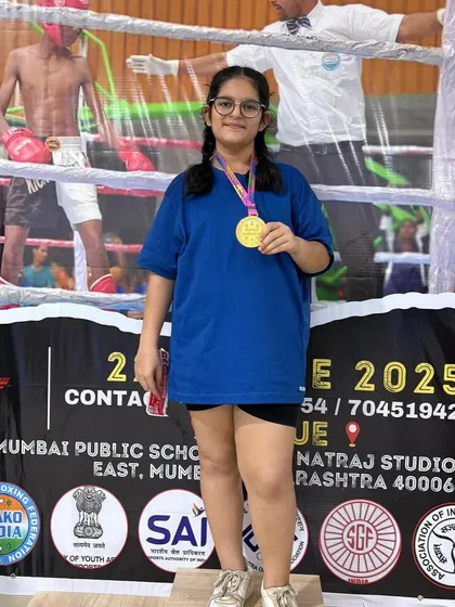 Prisha Sanghvi on the podium with her gold medal. We train our students not just to fight, but to win and stand proud of their achievements in kickboxing tournaments.