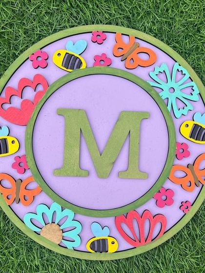 Another beautiful floral monogram. The combination of butterflies, bees, and flowers makes for a lovely, vibrant piece of wall art.