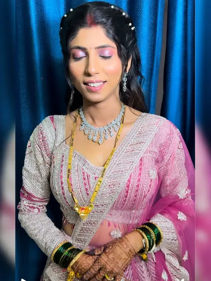 A beautiful bride ready for her reception. The makeup features a soft pink eyeshadow and a diamond necklace, creating a look of modern elegance.