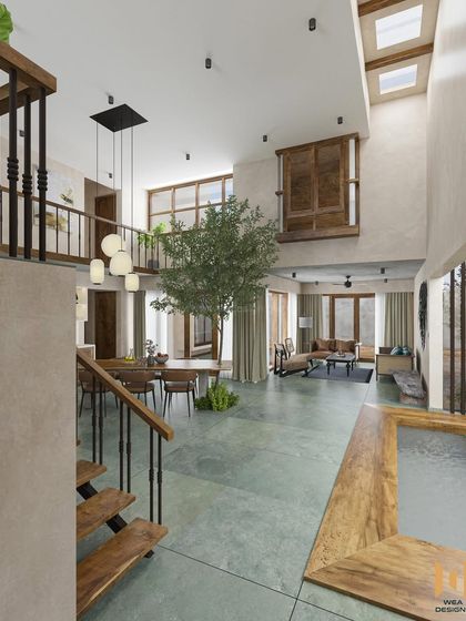 A wide shot from the staircase, capturing the entire open-plan ground floor with its water feature, dining area, and living space.