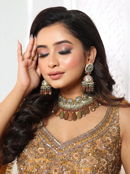 A glamorous look perfect for a sangeet or reception. The smoky eyes and nude lip are a classic combination that always looks stunning.