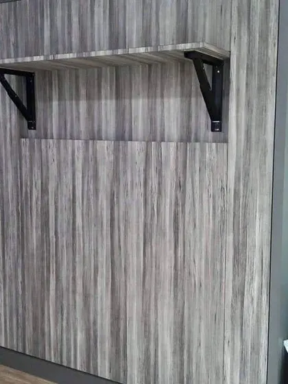 To add more function, I can build in features like this small, foldable shelf on the front of the Murphy bed unit. It's perfect for placing a glass of water or a book when the bed is closed.