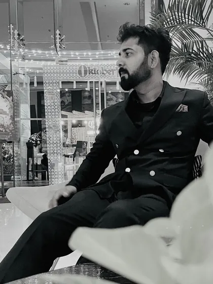 A candid moment, lost in thought before a show. These quiet times are crucial for mentally preparing to channel the right emotions into the sand and onto the screen.
