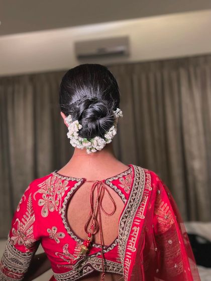 A full back view of the neat and tidy floral bun, a perfect choice for brides who want a traditional and sophisticated hairstyle.