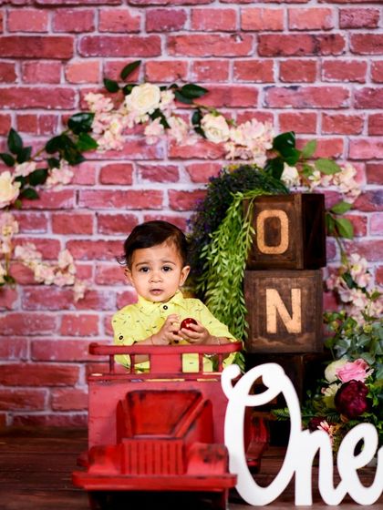 This first birthday setup combines our red brick wall, a red toy truck, and a freestanding "One" sign, offering multiple props in one cohesive theme for a varied gallery.