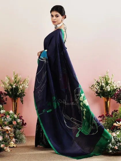 A navy blue saree with a contemporary abstract print and a bright green border.