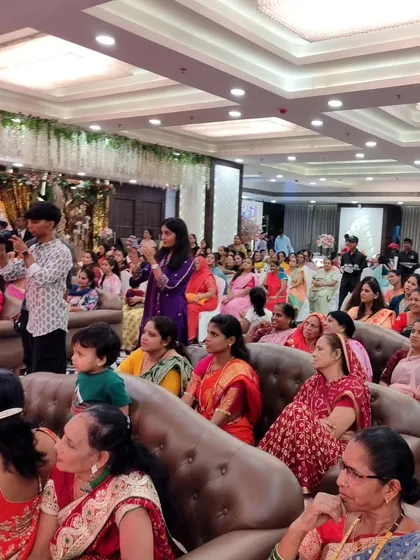 A shot of the engaged audience at a Jain family's baby naming ceremony. I ensure my hosting style connects with everyone, keeping guests entertained throughout the event.