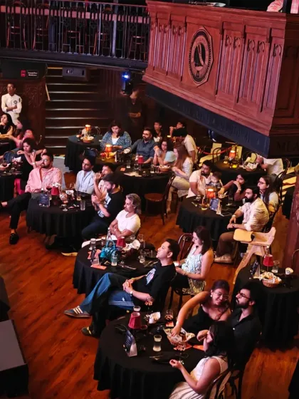 An overhead view of the audience at The Piano Man, Delhi. The layout shows how we create a theater-like experience in a fine-dining setting, ensuring everyone feels close to the action, both on-screen and on their plate.