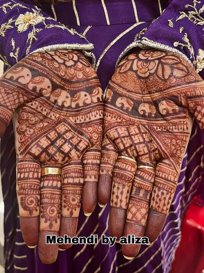 A henna stain check on a design with elephant motifs. The color is developing beautifully.