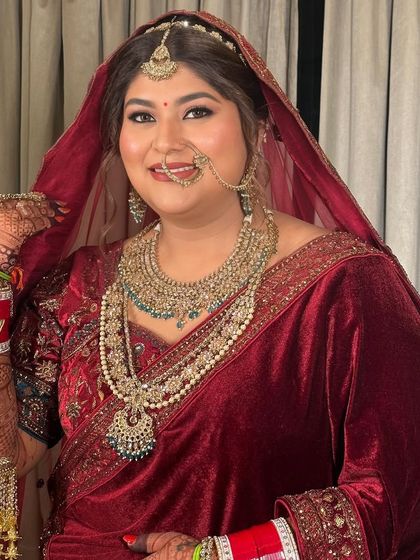 A happy bride ready for her big day. This image showcases the complete look, from the intricate jewelry to the flawless makeup that brings it all together.