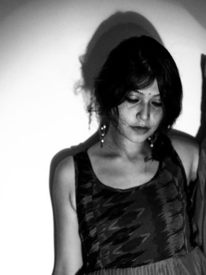 A portrait from 'Ignite' that plays with shadow and light against a wall. The mood is contemplative and artistic.