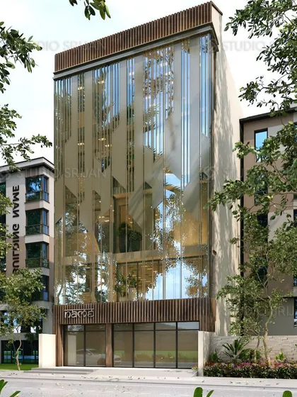An angled render of the Tagore Garden building, showing how the patterned glass interacts with light and reflections from the surrounding trees. The design is both artistic and functional.