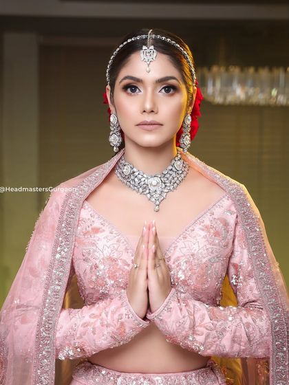 A graceful pose from our premium bridal photoshoot. The makeup is soft yet defined, creating a look of timeless elegance that is perfect for a modern bride.