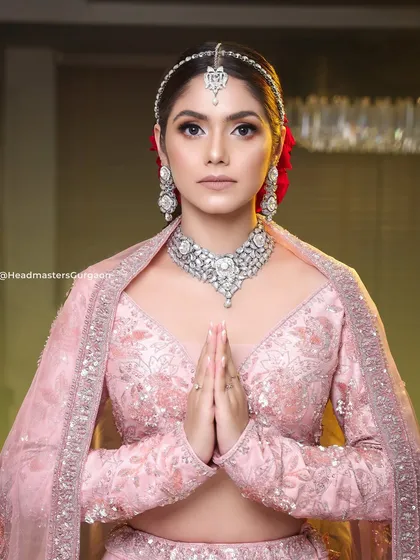 A graceful pose from our premium bridal photoshoot. The makeup is soft yet defined, creating a look of timeless elegance that is perfect for a modern bride.