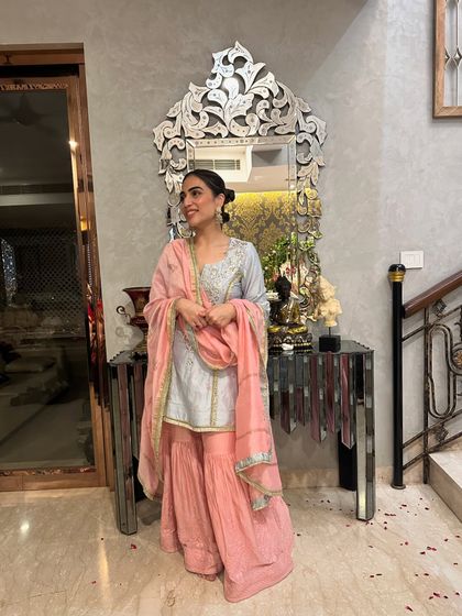 A smiling shot in my festive sharara set. The bun hairstyle keeps the look neat and puts the focus on the outfit's details.