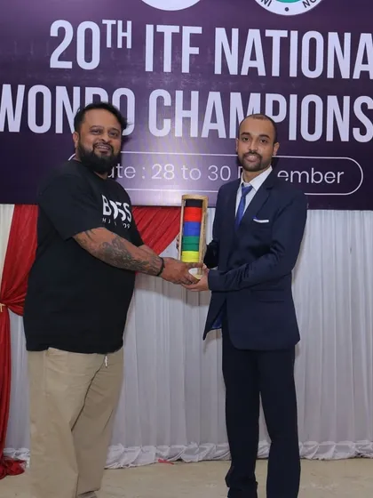 Receiving a memento while officiating at the 20th National Taekwon-Do ITF Championship. Being an official is a critical role that upholds the integrity and fairness of the sport.