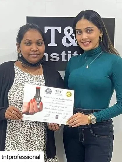 A student proudly displays her certificate after completing our intensive masterclass. She is now equipped with the latest skills.