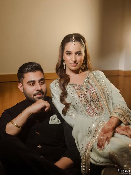 An elegant portrait of Anisha and Abhishek from their Roka, her looking at the camera while he gazes at her.