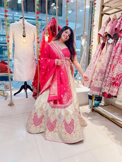 This client looks stunning in a classic white and pink lehenga. The joy of finding the perfect outfit is priceless.
