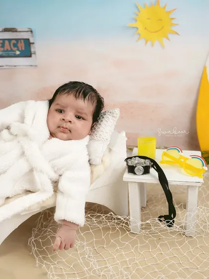 Lounging on a miniature beach chair, this baby is the picture of relaxation. Themed shoots are all about creativity and fun.