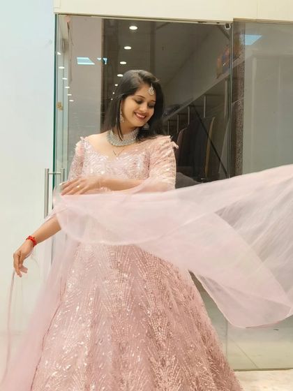 A candid shot of a client enjoying a twirl in the pink embroidered gown. The sheer joy and elegance this gown brings is clear to see.
